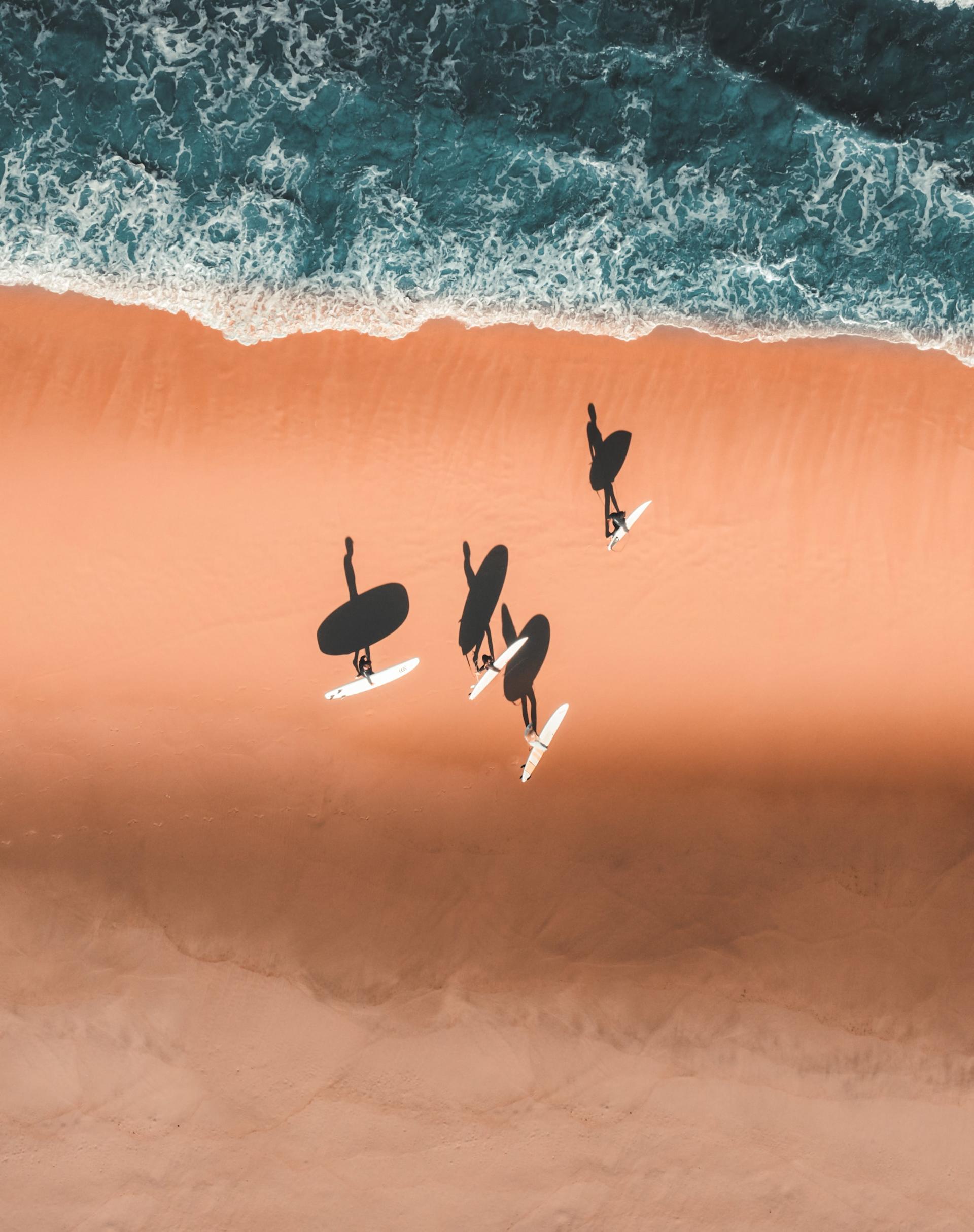 Drove view of surfers on the beach