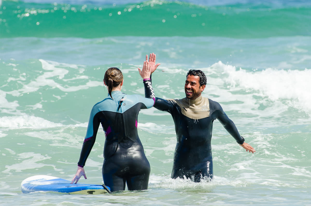high five surfers