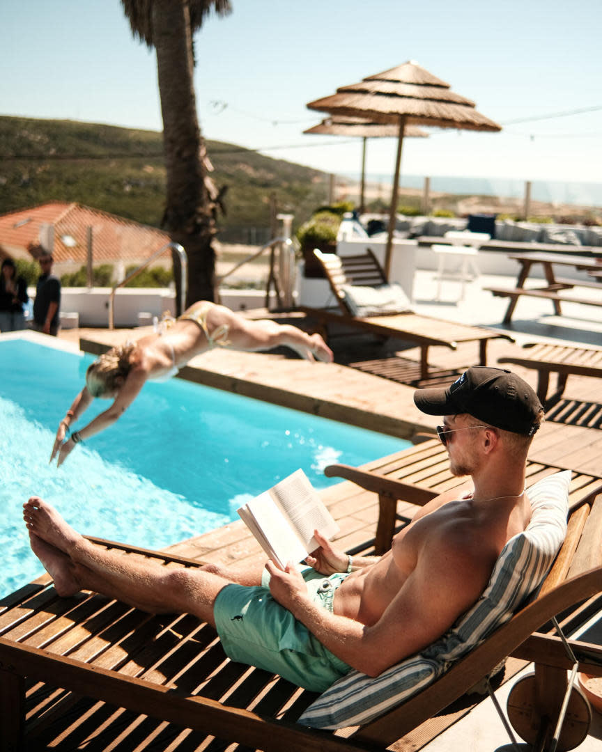 surfcamp lapoint surf man chilling by pool