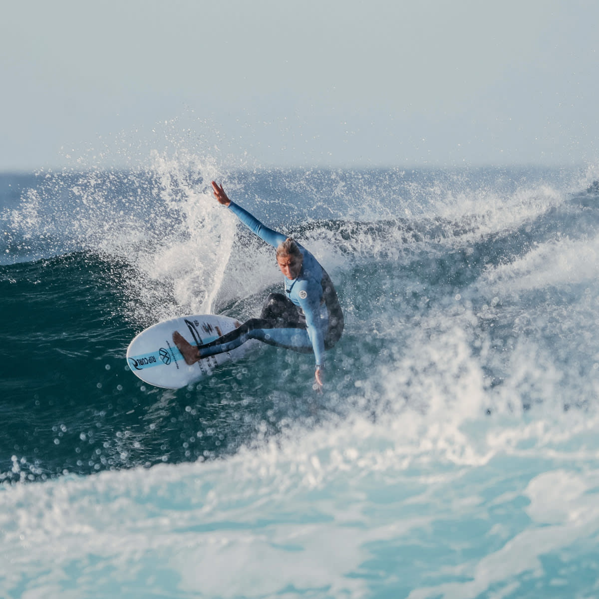 woman-surfing-in-fuerteventura-wetsuit-lapoint-surf-camp