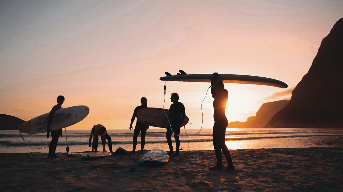 Surfers on the sand in Hoddevik Norway