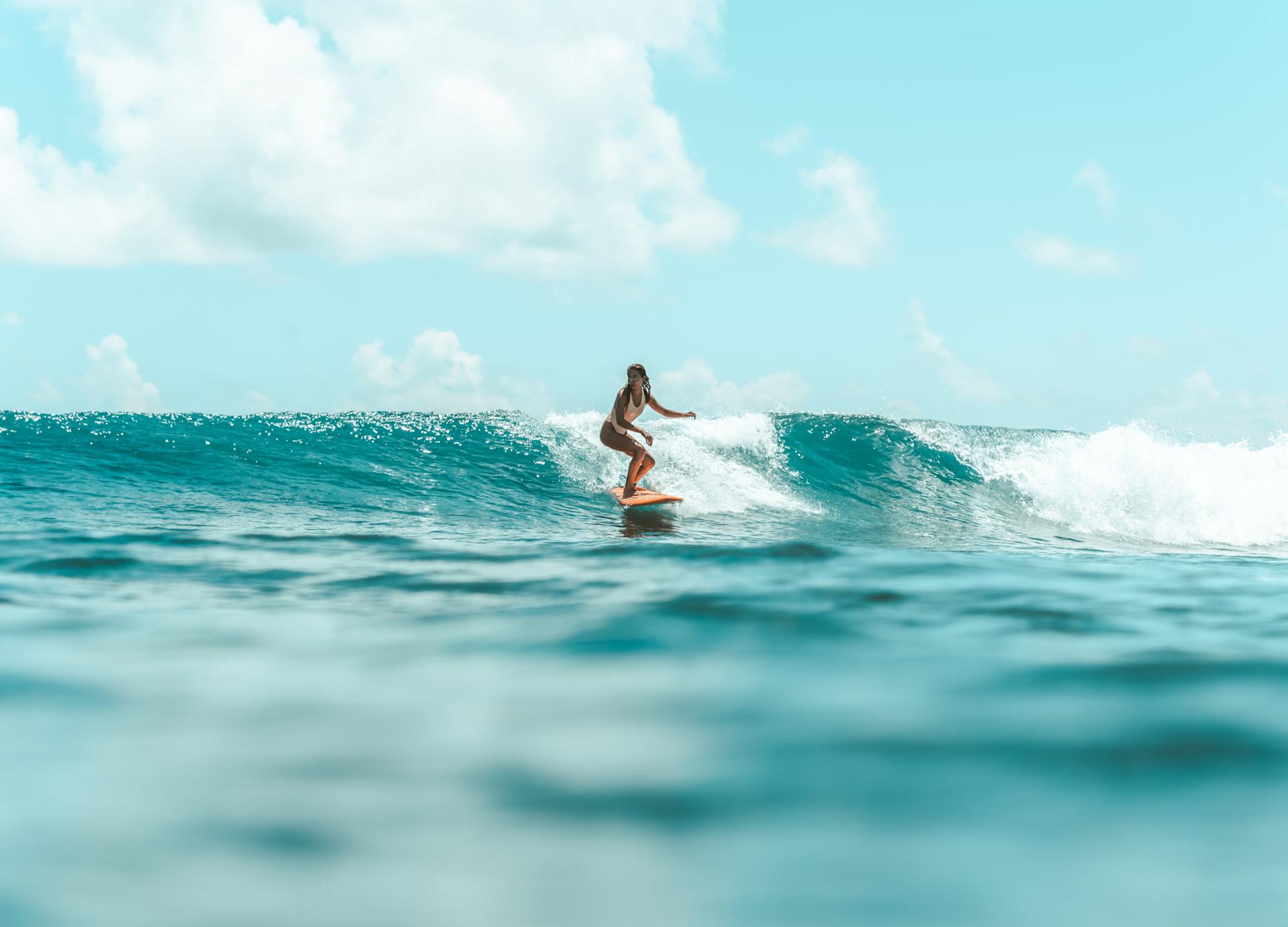 Girl surfing in the Maldives