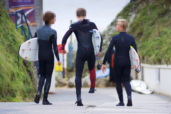 surfers on the street holding boards