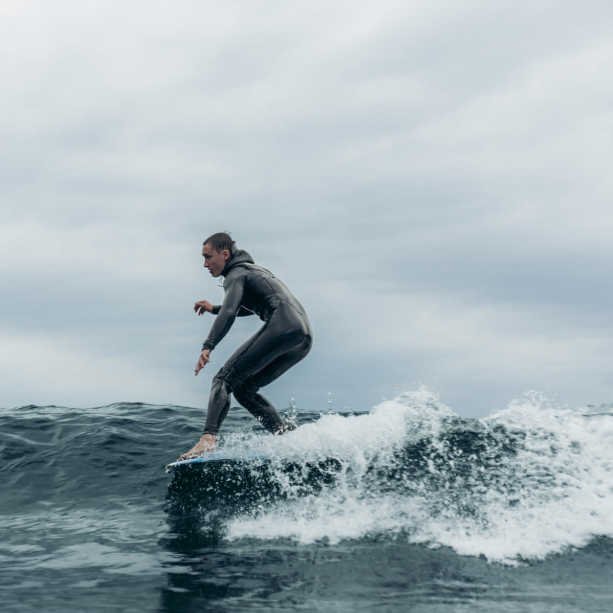 Man-surfing-norway-wetsuit-lapoint-surf-camp