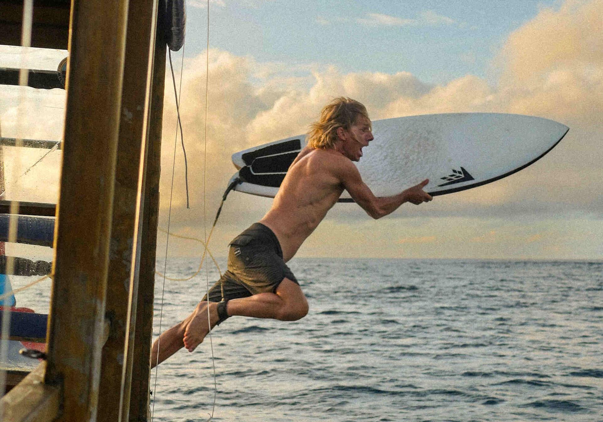 man jumping from boat lapoint surf camp