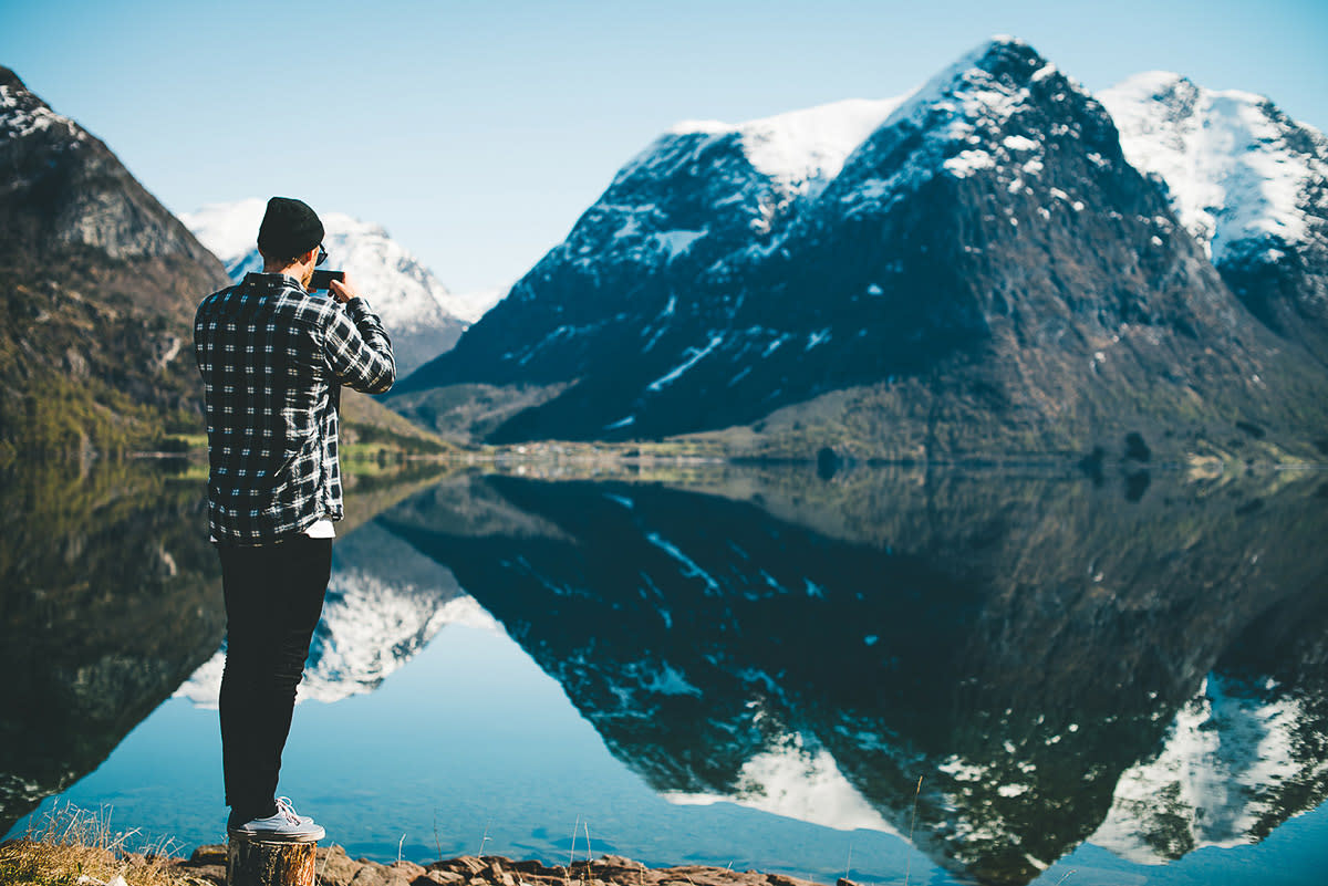 Guy taking picture of fjord