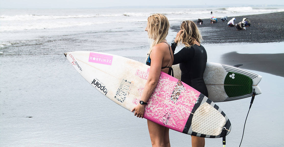 two surfer girls looking at the ocean lapoint