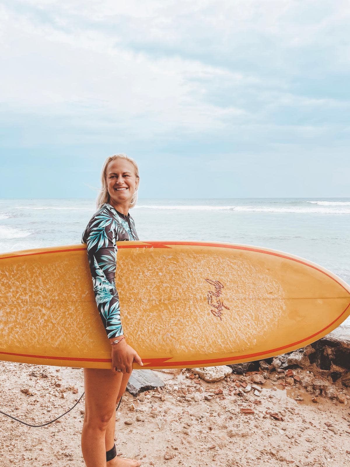 Surfer girl on the beach with surf board