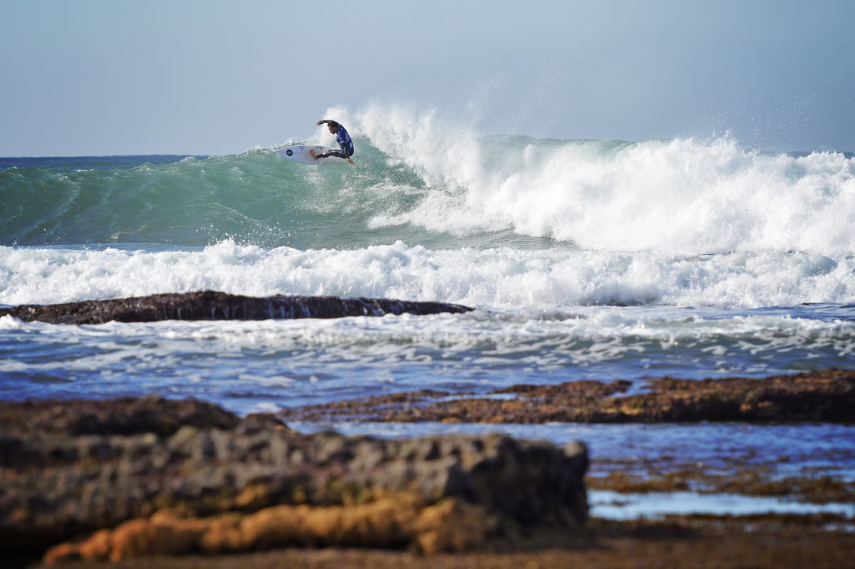 Surfer catching wave in Ericeira