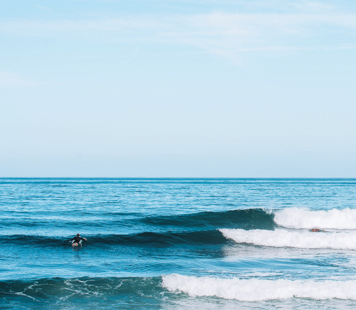 Surfer paddling out Ericeira
