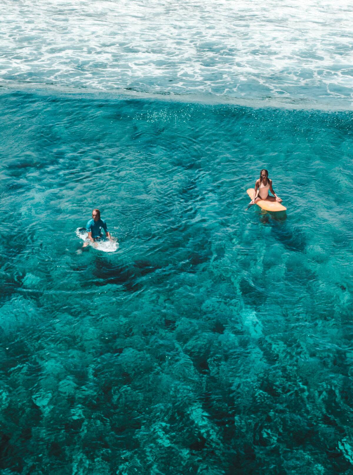 Surfers sitting lineup maldives